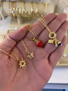 Collar de dijes de sol, mariposa, fresa y viajero. Al mayor